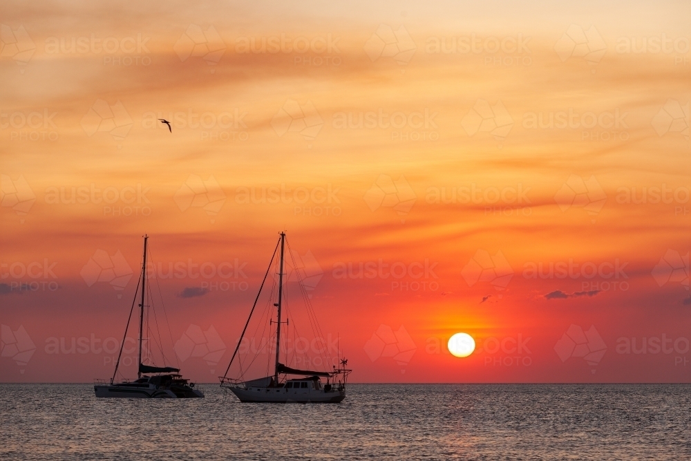 Anchored yachts at sunset in Seisia silhouetted - Australian Stock Image