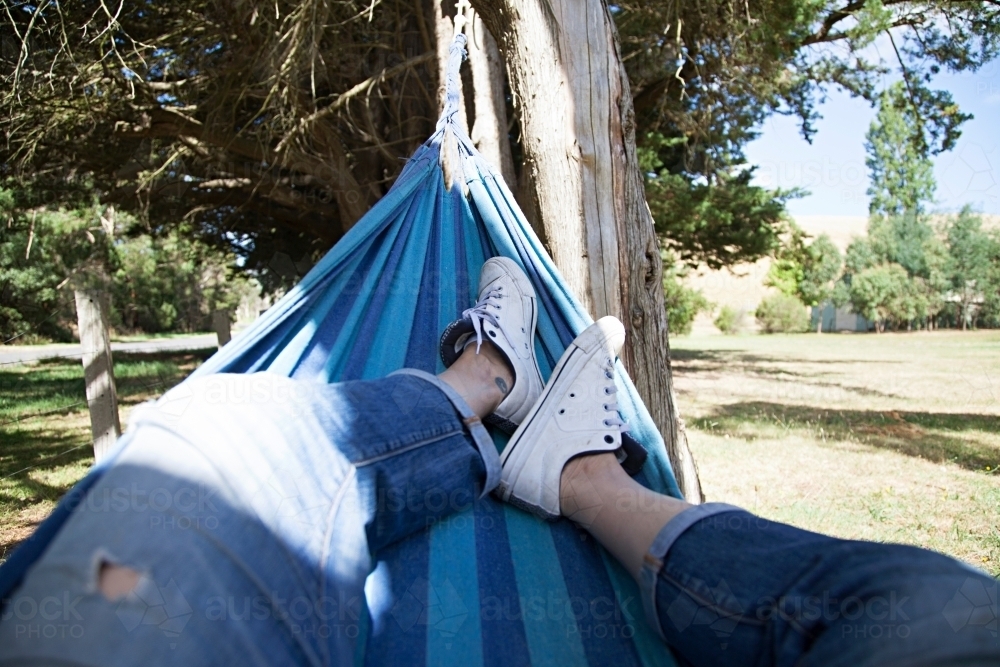 Anonymous woman's leg lazing in a hammock - Australian Stock Image