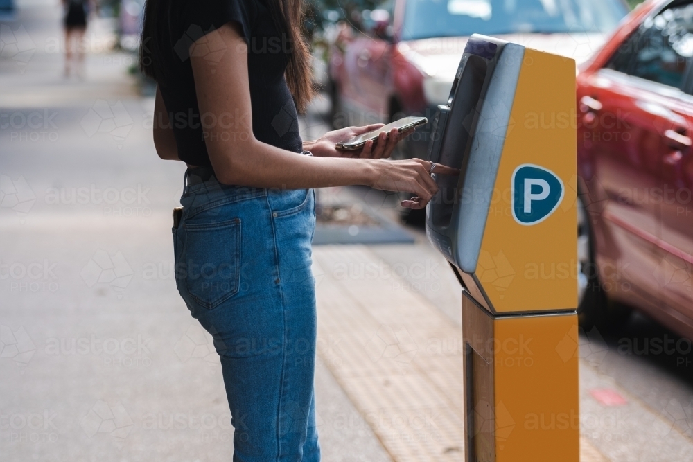 anonymous woman using car parking machine : Austockphoto anonymous woman using car parking machine - Australian Stock Image