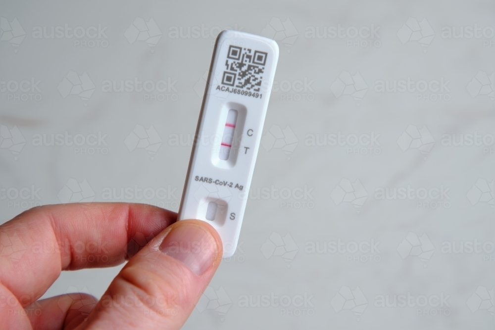 Antigen rapid test kit showing a positive result - Australian Stock Image