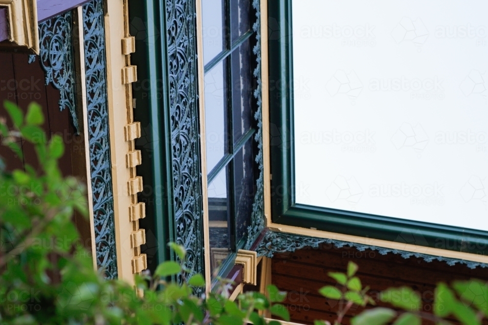 Antique wrought iron lattice work around a window - Australian Stock Image