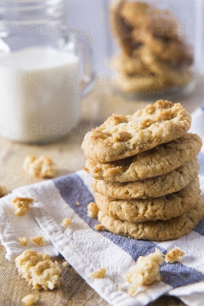 Anzac Biscuitss with milk on a chopping board - Australian Stock Image