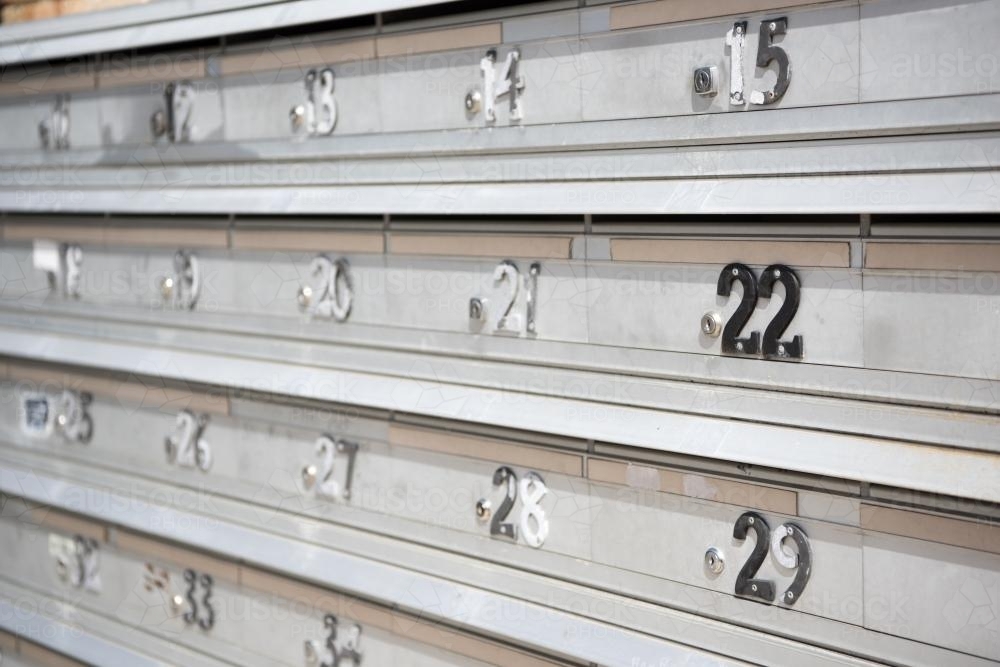 apartment block aluminium mailboxes with worn numbers - Australian Stock Image