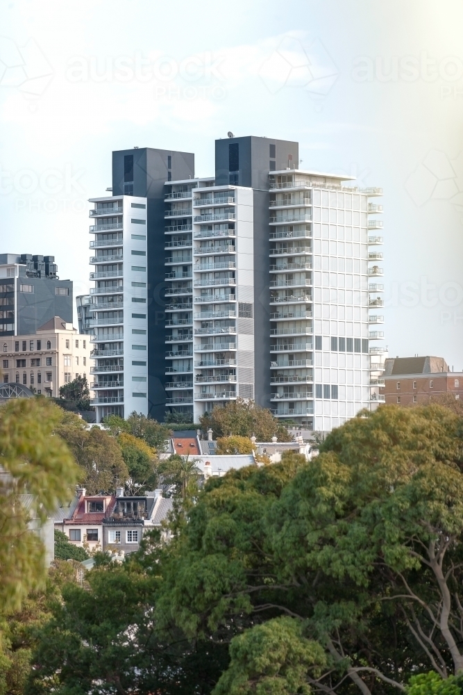 Apartment buildings and terraces among trees - Australian Stock Image