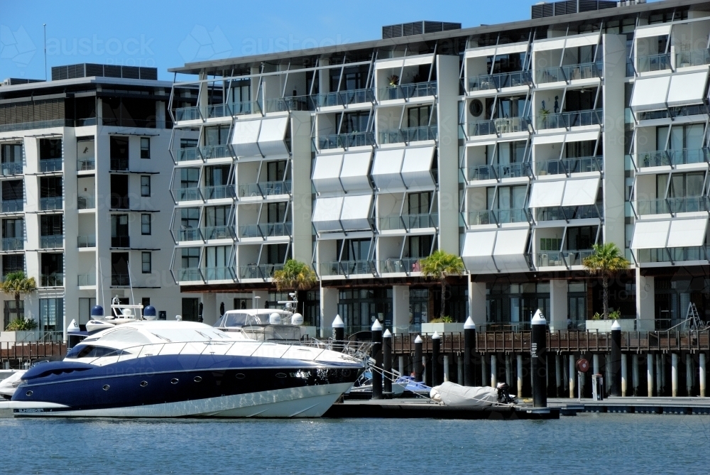 Apartments beside the water with boat - Australian Stock Image