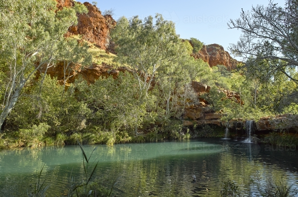 Aqua pool and waterfall in remote location - Australian Stock Image