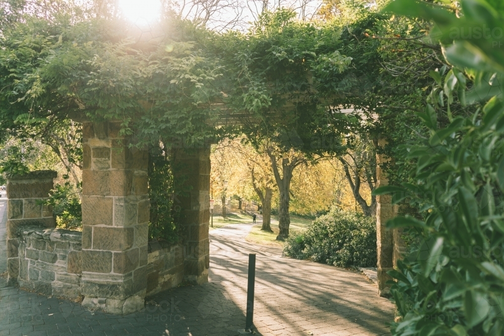 Arbour gate into park during afternoon - Australian Stock Image