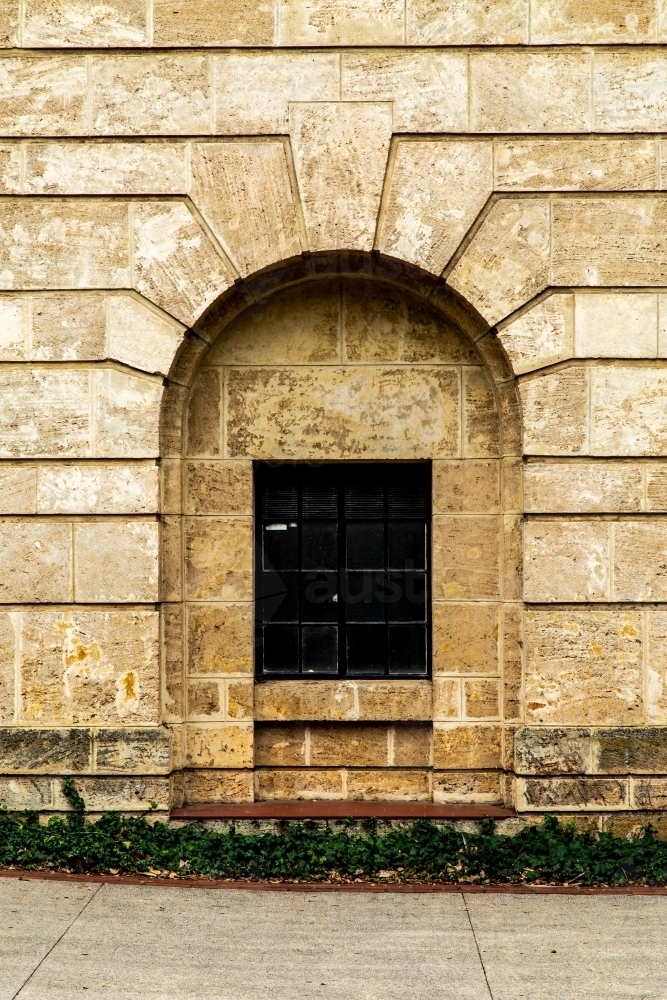 Arch around window in old stone building. - Australian Stock Image