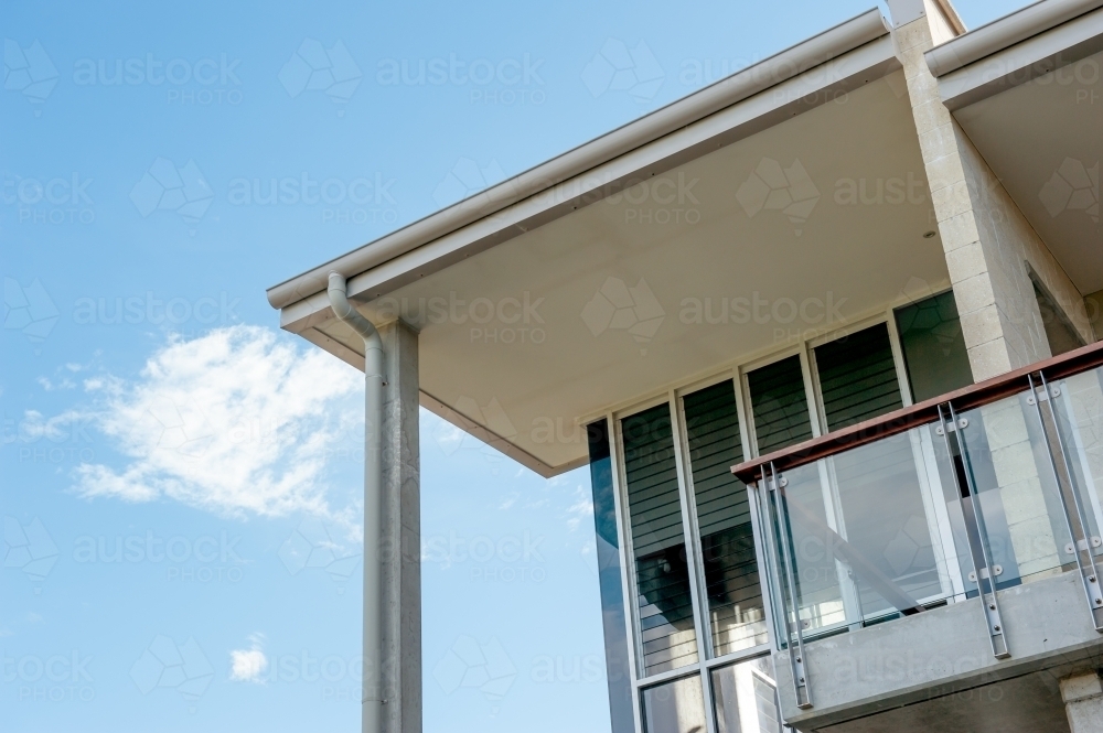 architectural detail of modern beach house with glass window louvres and balcony - Australian Stock Image