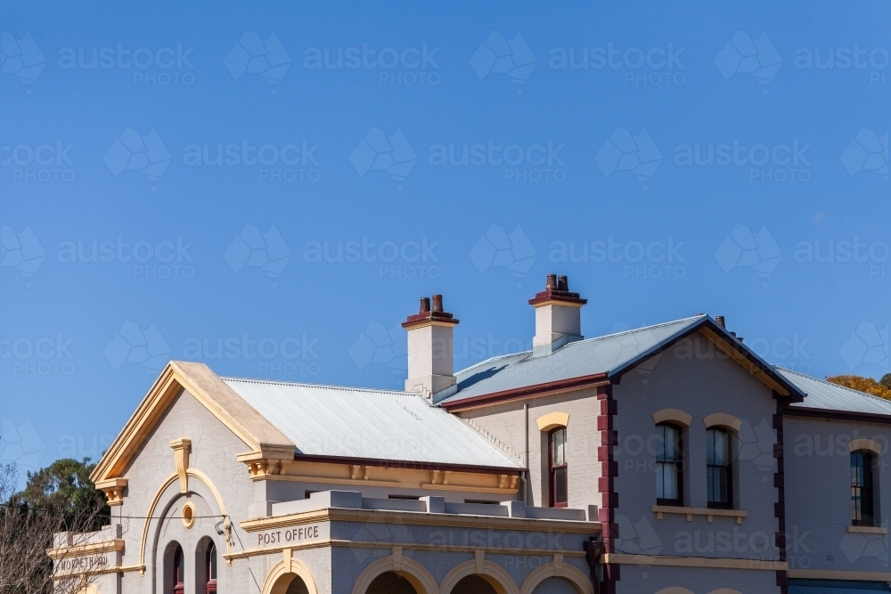 Architecture of old sunlit building in Morpeth suburb of Maitland under blue sky - Australian Stock Image