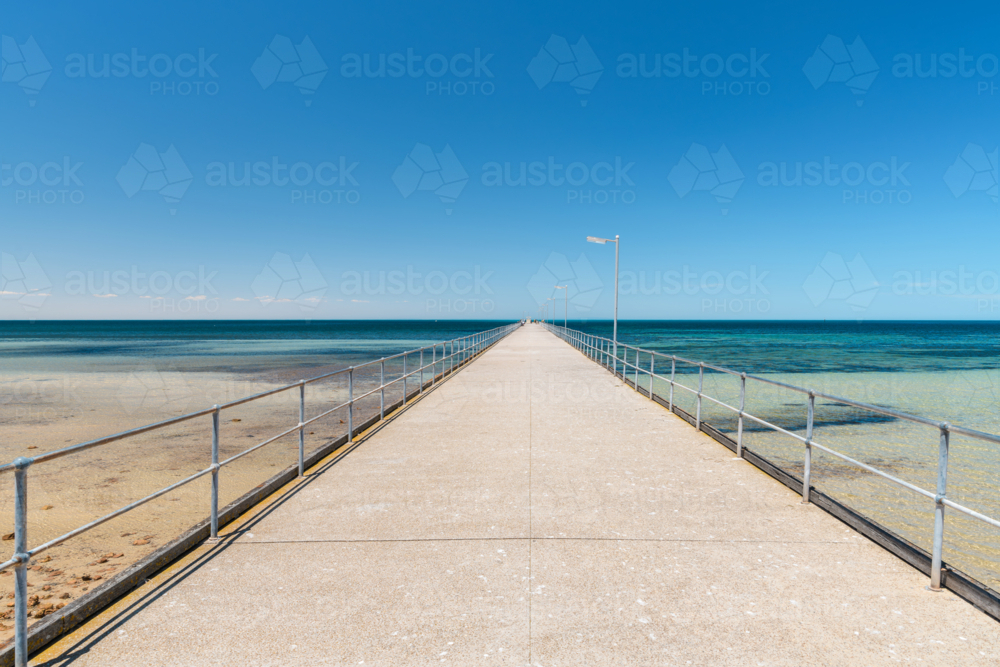Ardrossan Jetty on a bright day against blue sky, Yorke Peninsula, South Australia - Australian Stock Image