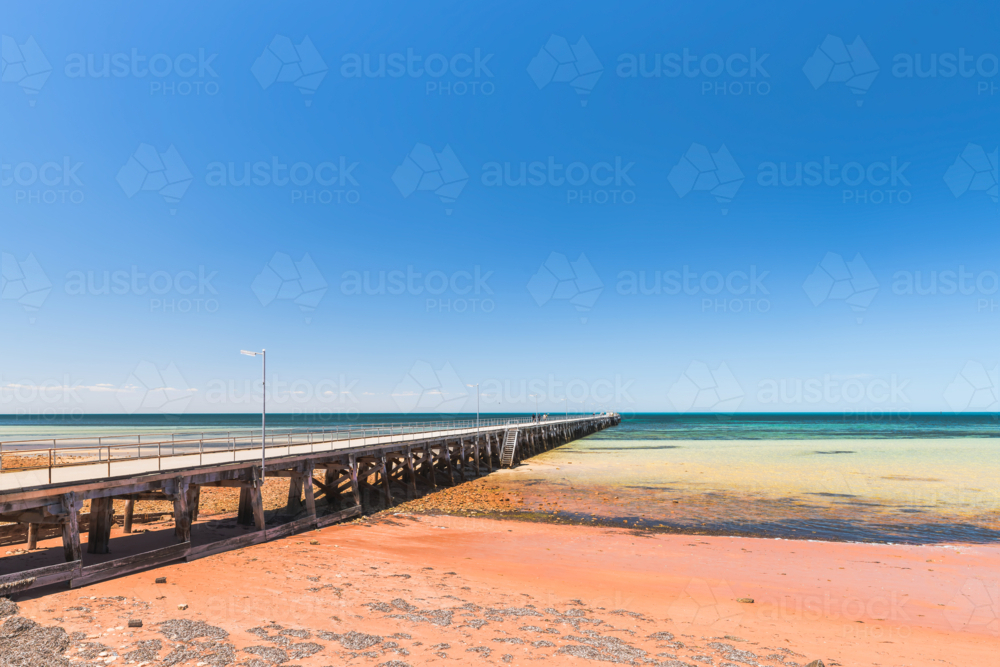 Ardrossan Jetty with people on a bright day against blue sky, Yorke Peninsula, South Australia - Australian Stock Image
