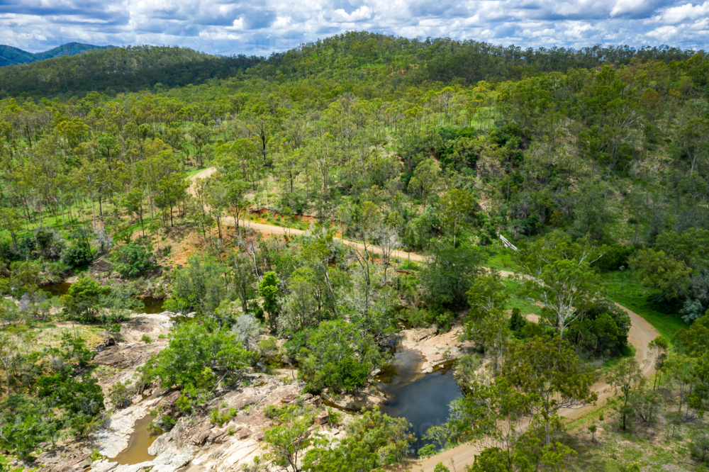 Area surrounding a freshwater swimming hole in the summer - Australian Stock Image
