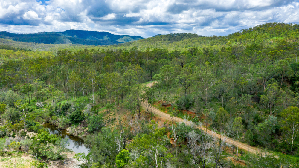 Area surrounding a freshwater swimming hole in the summer - Australian Stock Image