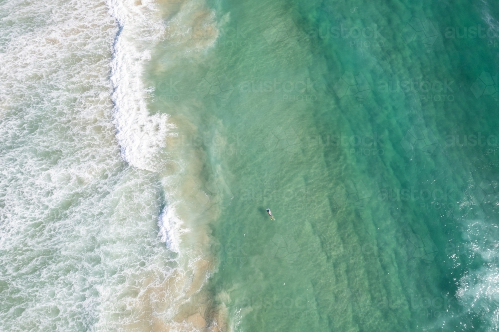 Arial view of the ocean where the waves are breaking near the shore. - Australian Stock Image