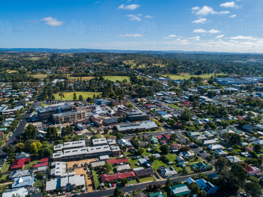 Armidale aerial streetscape in bright sunlight with houses lining roads through rural city - Australian Stock Image
