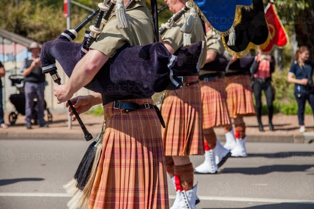 Image of Army band in kilts playing bagpipes in military freedom of