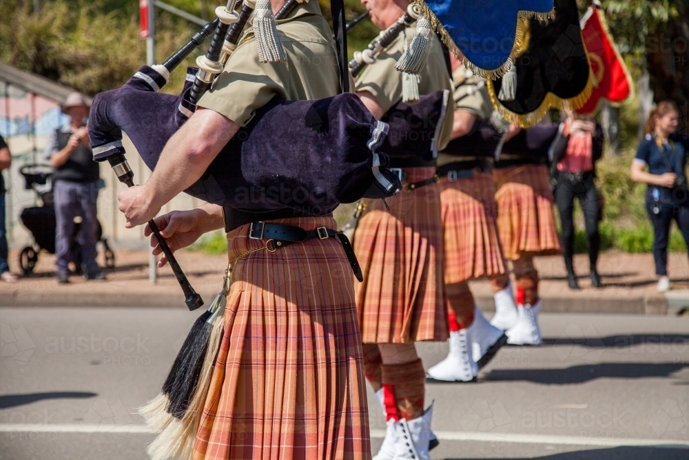 Army band in kilts playing bagpipes in military freedom of entry parade - Australian Stock Image