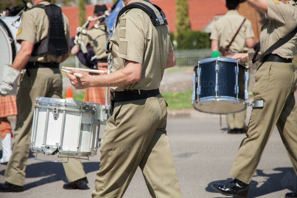 Image of Army drum players marching down the road in celebration of