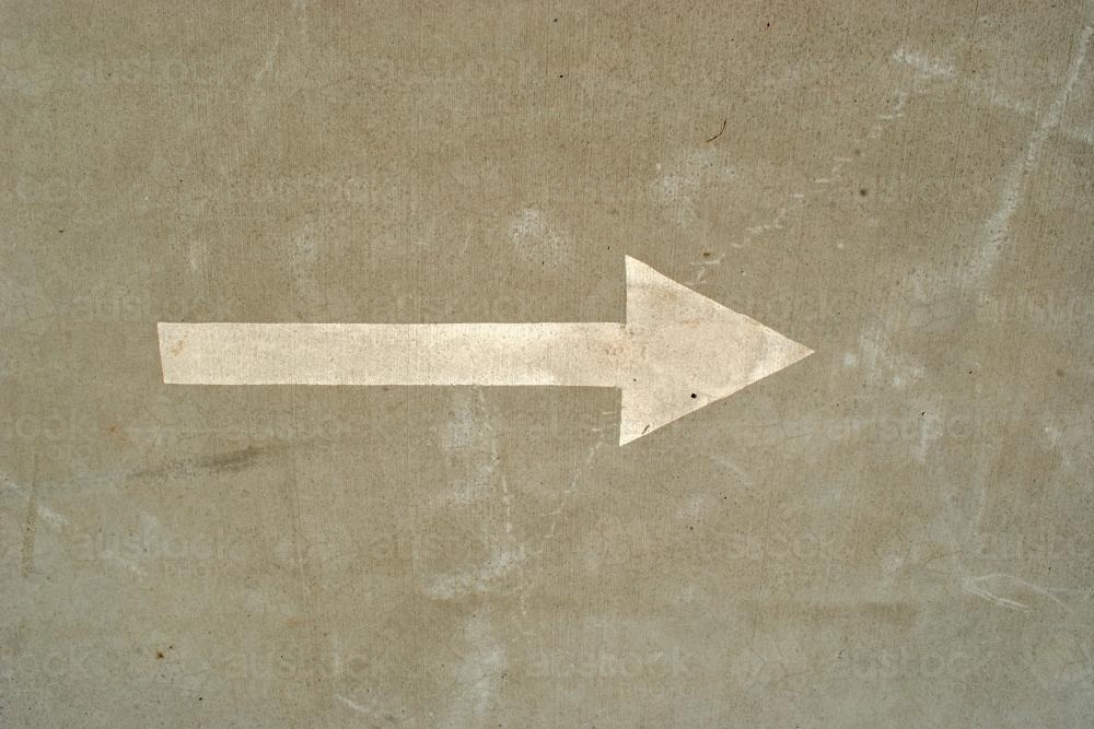 Arrow painted on the road, pointing to the right - Australian Stock Image