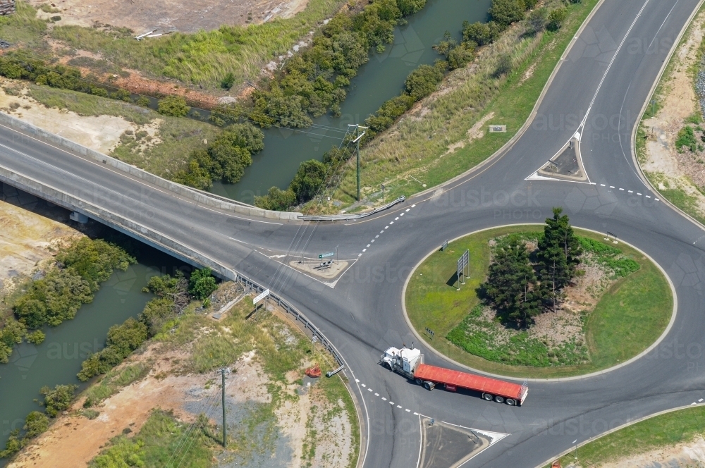 Image of Articulated semi trailer truck going around a roundabout next