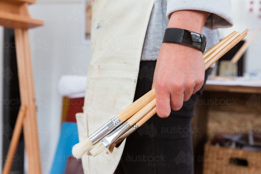 Artist holding brushes - Australian Stock Image