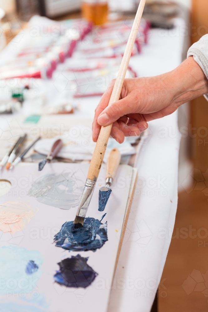 Artist painting in studio - Australian Stock Image