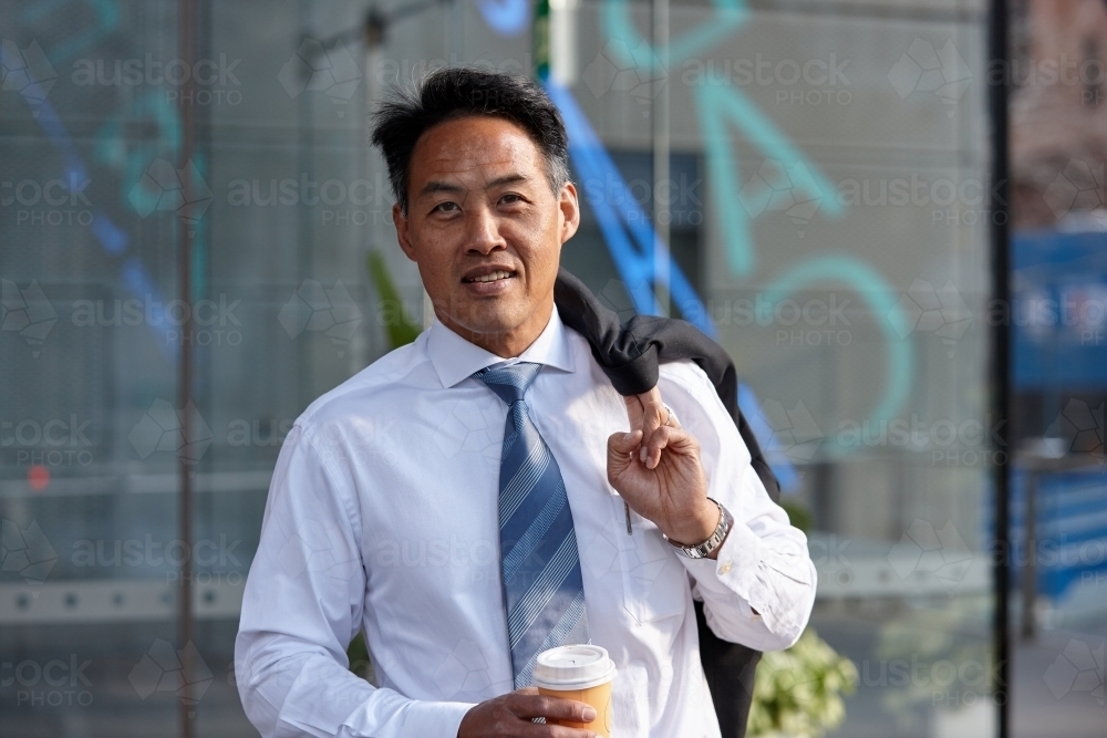 Asian businessman in city - Australian Stock Image