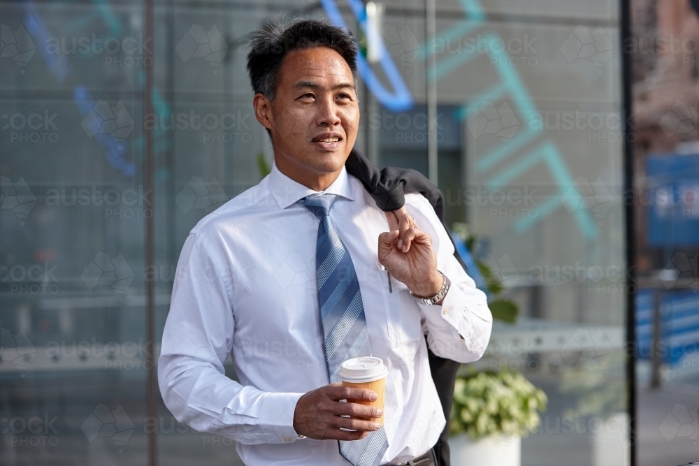 Asian businessman in city - Australian Stock Image