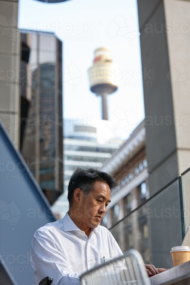 Asian businessman in city - Australian Stock Image
