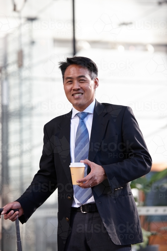 Asian businessman in city - Australian Stock Image