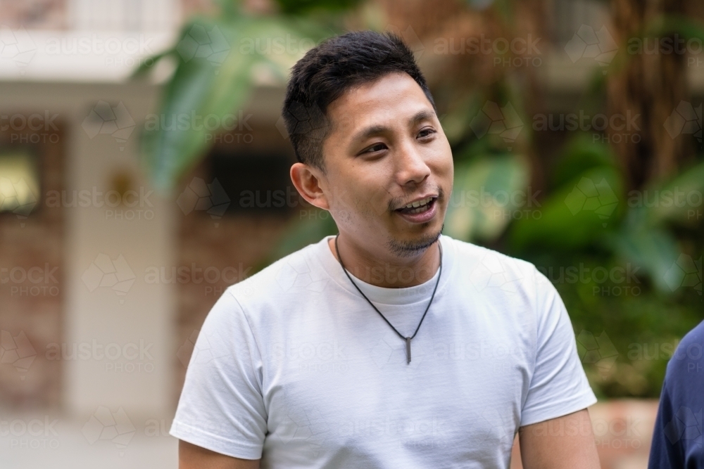 asian man talking - Australian Stock Image