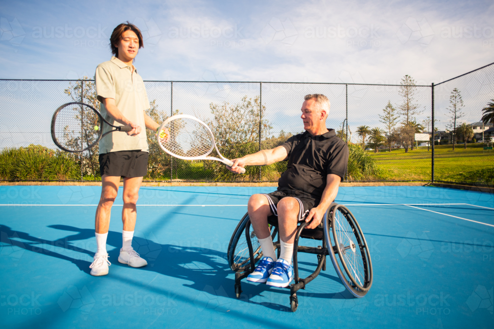 Image Of Asian Man Tennis Coach Gives Instruction To A Player In A image-of-asian-man-tennis-coach-gives-instruction-to-a-player-in-a