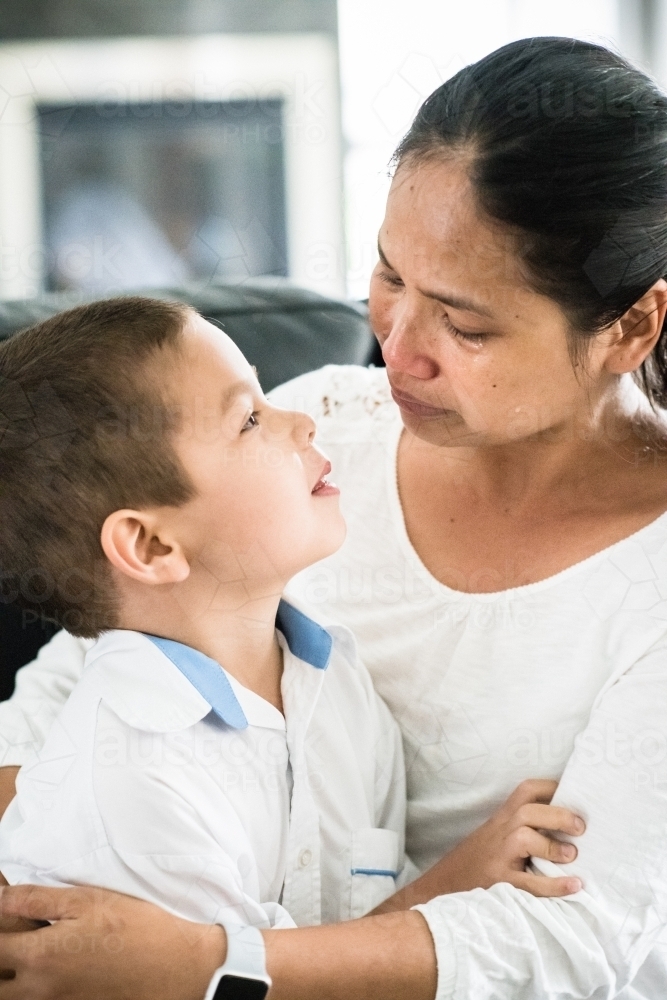 Asian mother cries as she sends her boy off to his first day of school - Australian Stock Image
