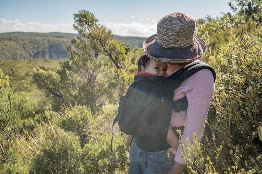 Asian mum outside walking in the summer sun with her mixed race baby boy - Australian Stock Image