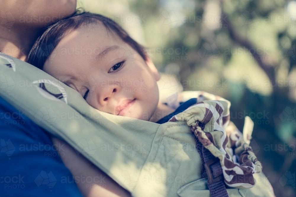 Asian mum outside walking in the summer sun with her mixed race baby boy - Australian Stock Image