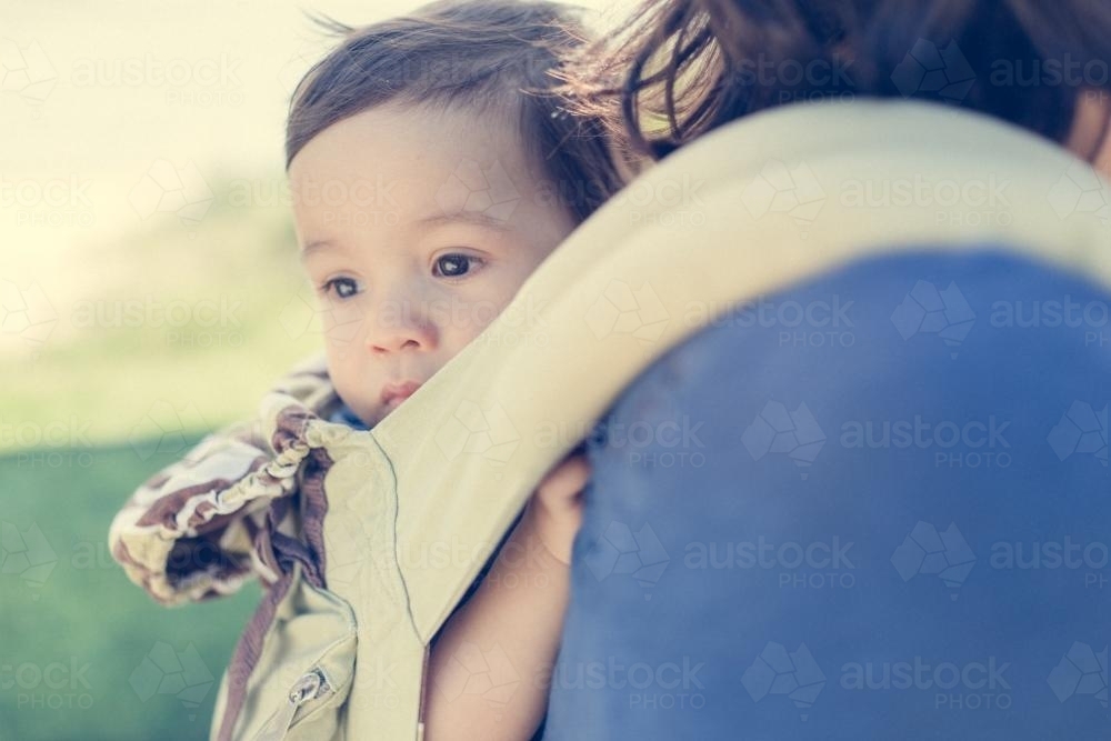 Asian mum outside walking in the summer sun with her mixed race baby boy - Australian Stock Image