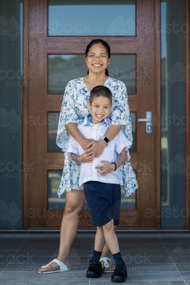 Asian mum sending her boy off to school on his first day of school - Australian Stock Image