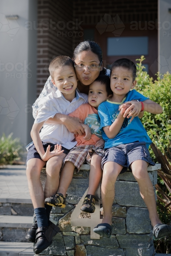 Asian mum sending her boys off to school on their first day of school - Australian Stock Image