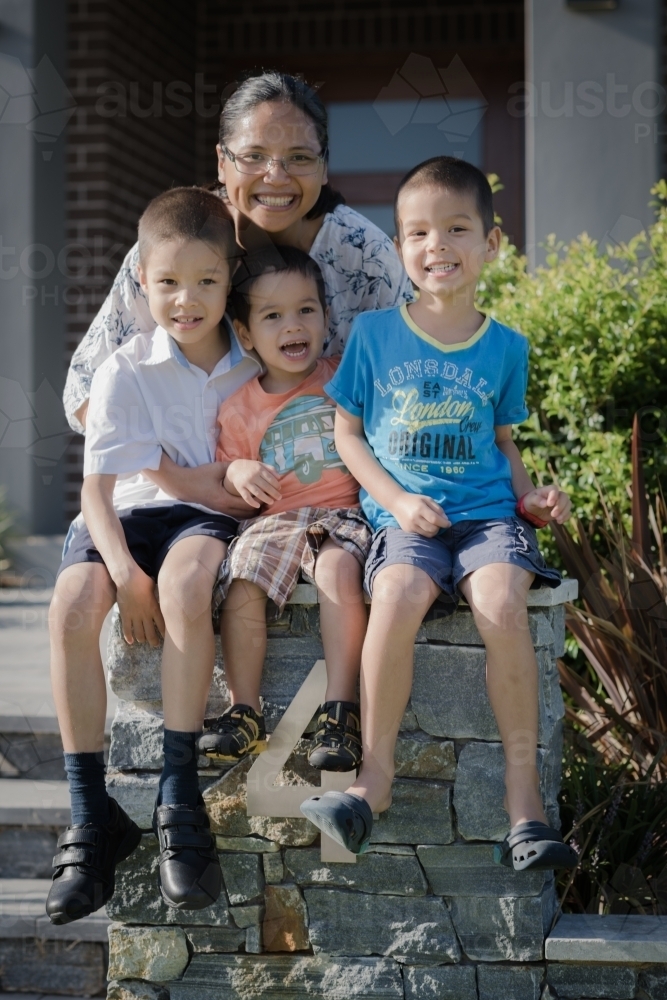 Asian mum sending her boys off to school on their first day of school - Australian Stock Image