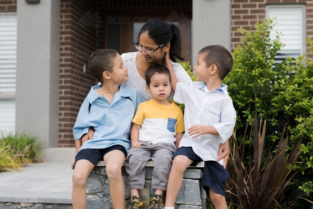 Asian mum sending her boys off to school on their first day of school - Australian Stock Image
