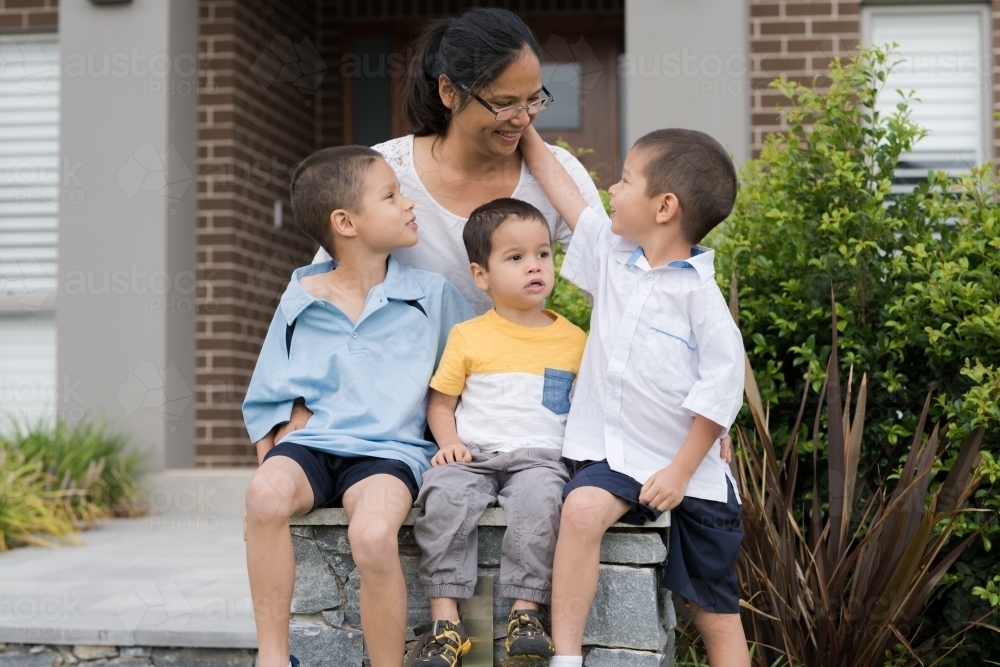 Asian mum sending her boys off to school on their first day of school - Australian Stock Image