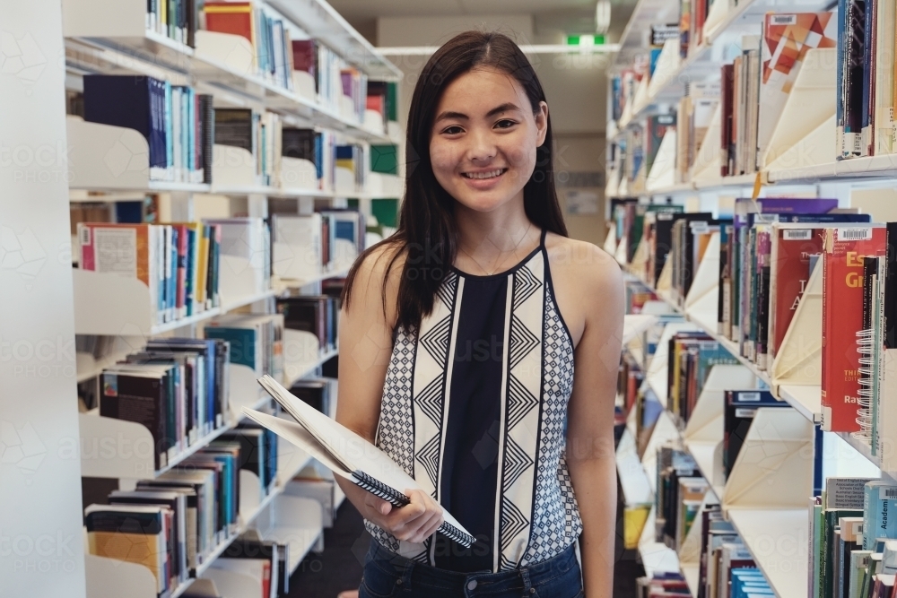 Asian students in university library - Australian Stock Image