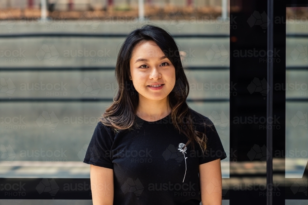 asian woman at train station - Australian Stock Image
