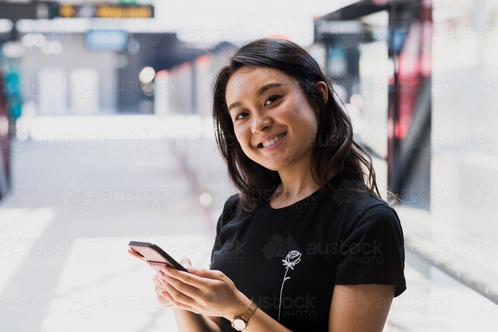 asian woman at train station - Australian Stock Image