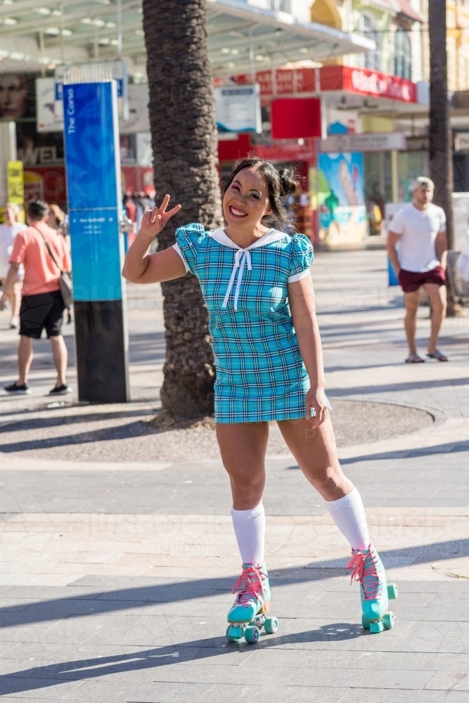 asian woman making peace sign - Australian Stock Image