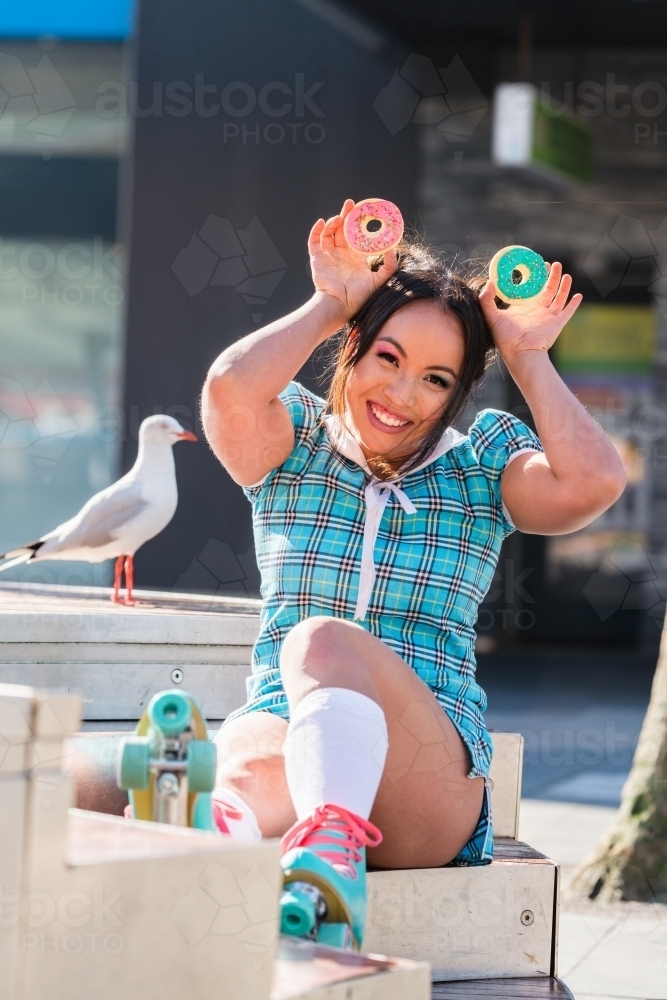 asian woman with cookies, doughnuts - Australian Stock Image