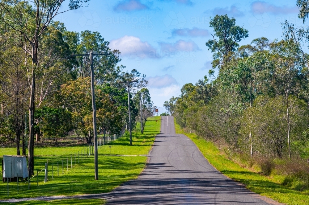 Asphalt country road, with telephone poles - Australian Stock Image