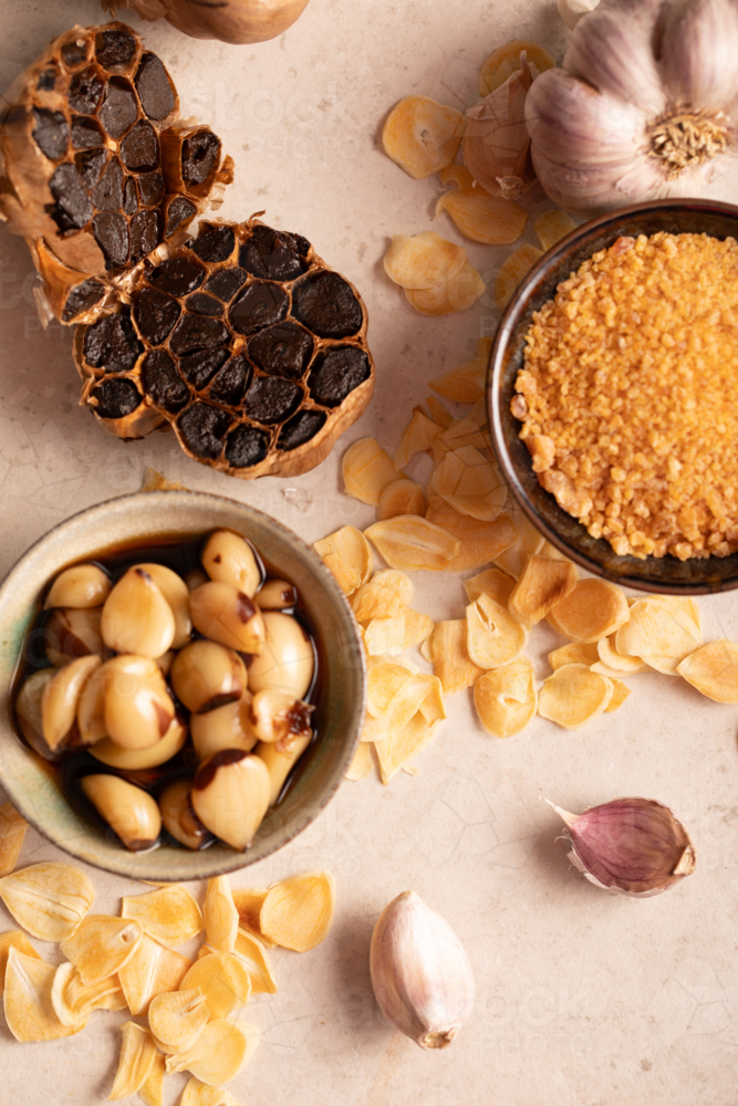 Assorted Garlic Types and Garlic Products on Neutral Background - Australian Stock Image