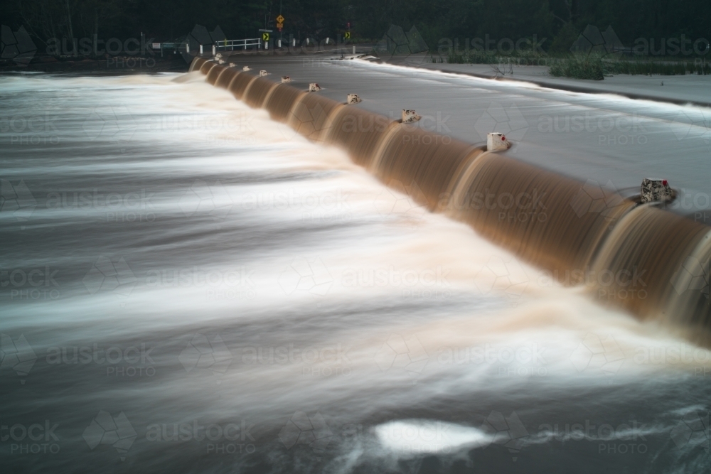 Audley weir in flood with water over road - Australian Stock Image